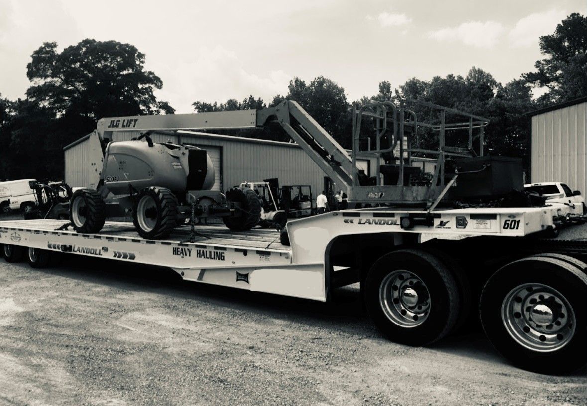 Tow truck pulling a semi-truck from a ditch at night.