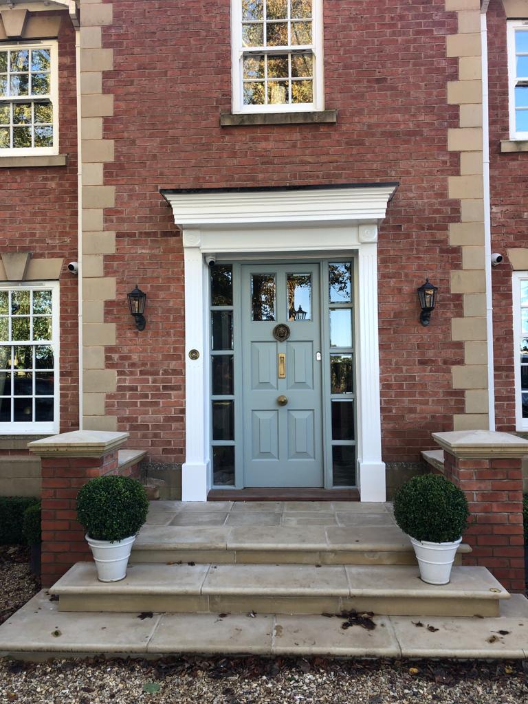 This is a picture of a front door which has had green exterior paint as the main colour. This picture was taken by one of the team at Painters and decorators Leicester