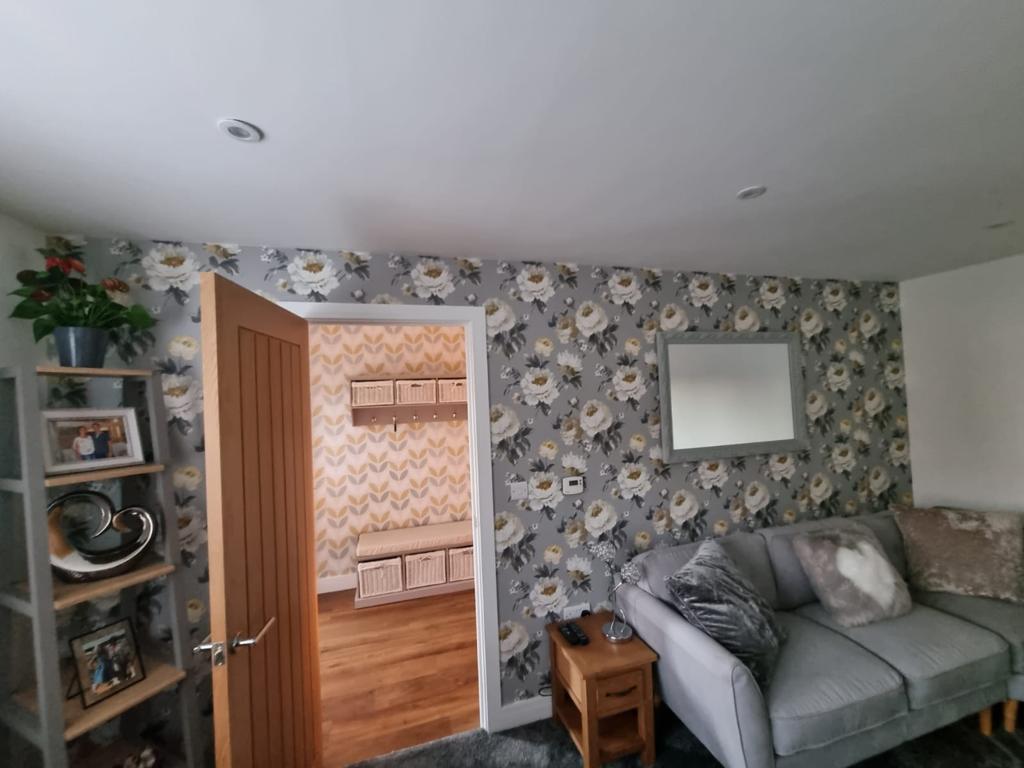 This is a picture of one of our wallpapering jobs. This is a designer wallpaper with a grey background and white roses