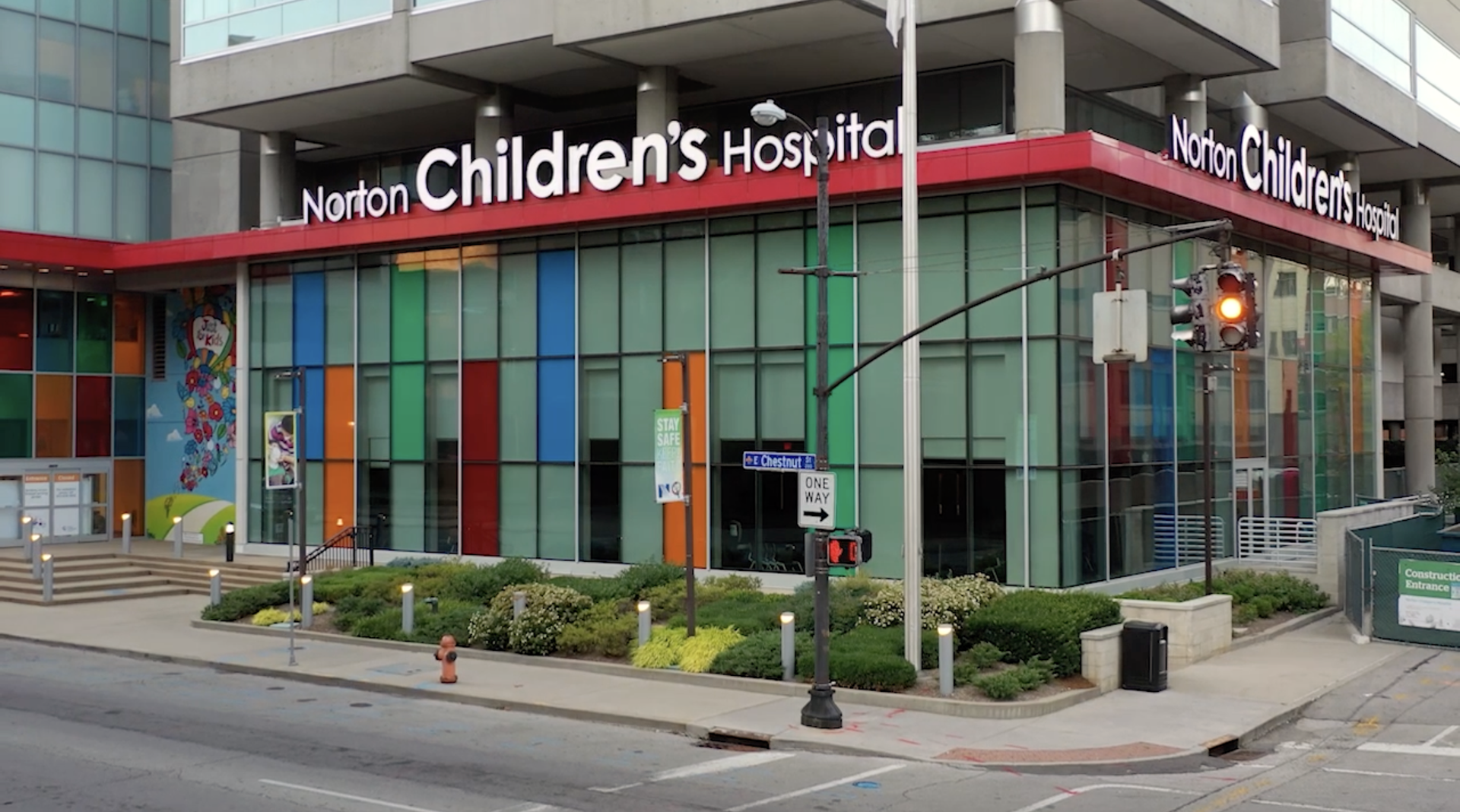 The exterior of Norton Children's Hospital in Louisville, KY, featuring colorful glass panels and a red signage border.