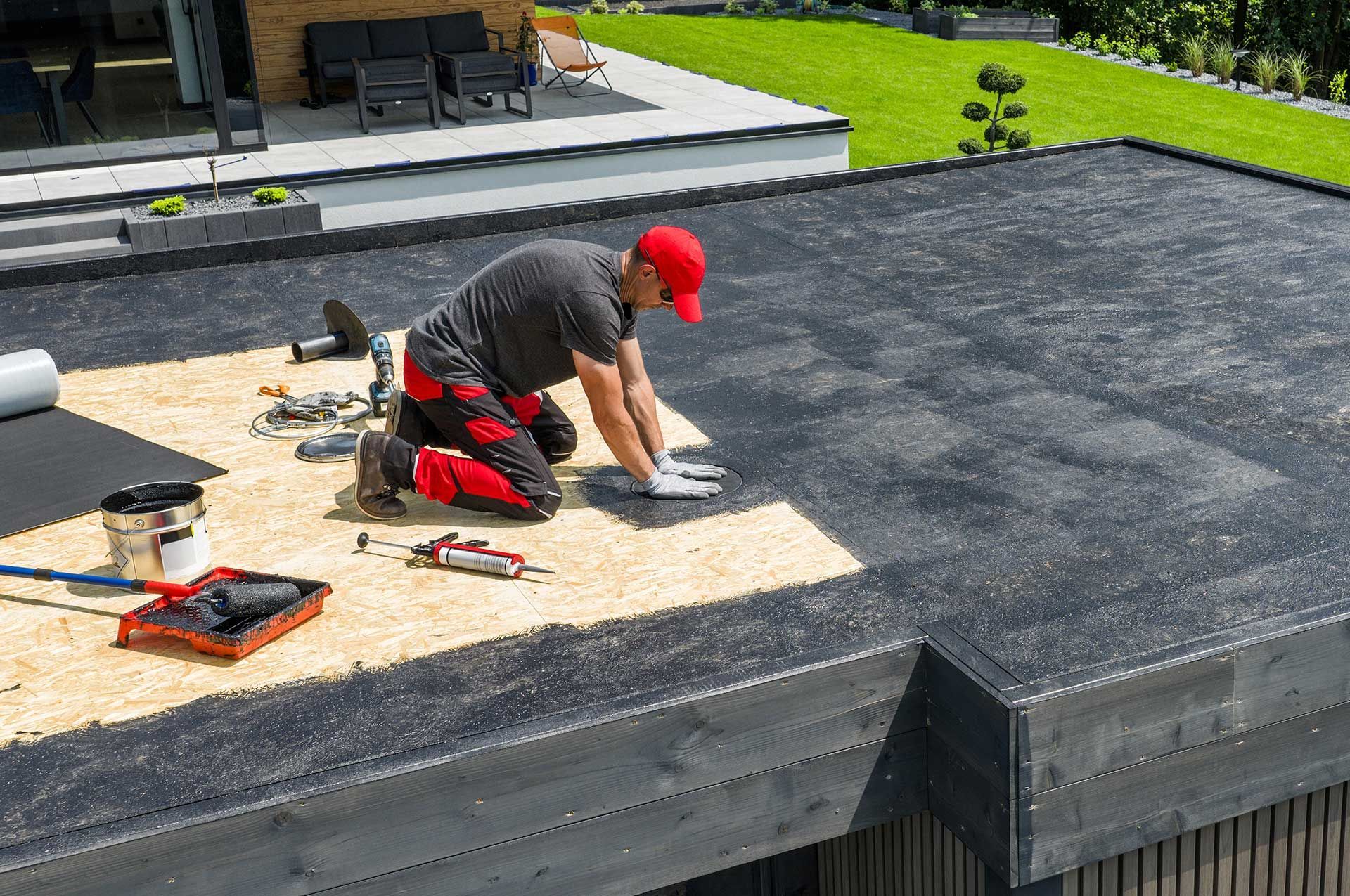 Worker Installing EPDM Roofing Material