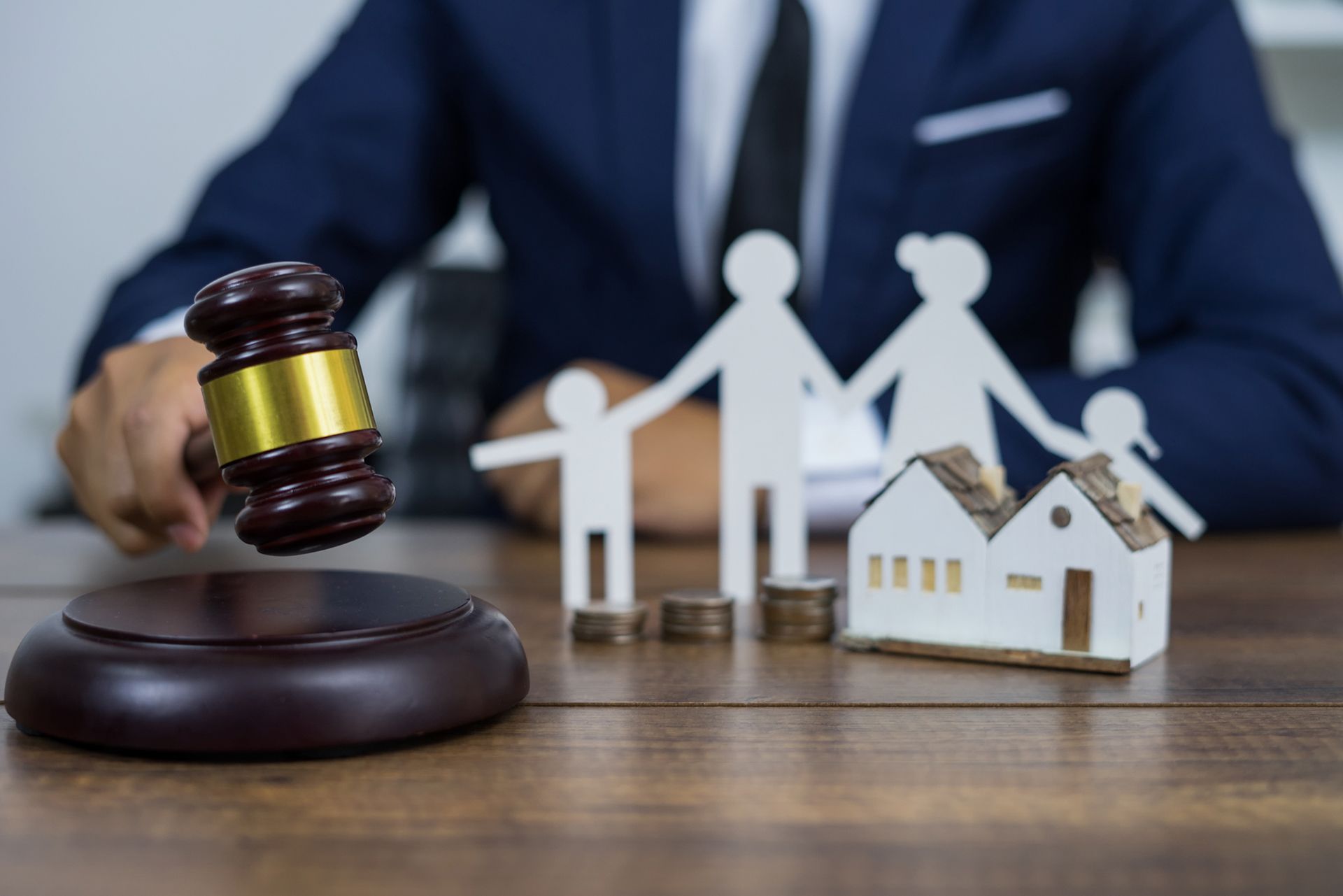 Family figure and gavel symbolizing legal support from a trusted local family law firm. Family figure and gavel symbolizing legal support from a trusted local family law firm.