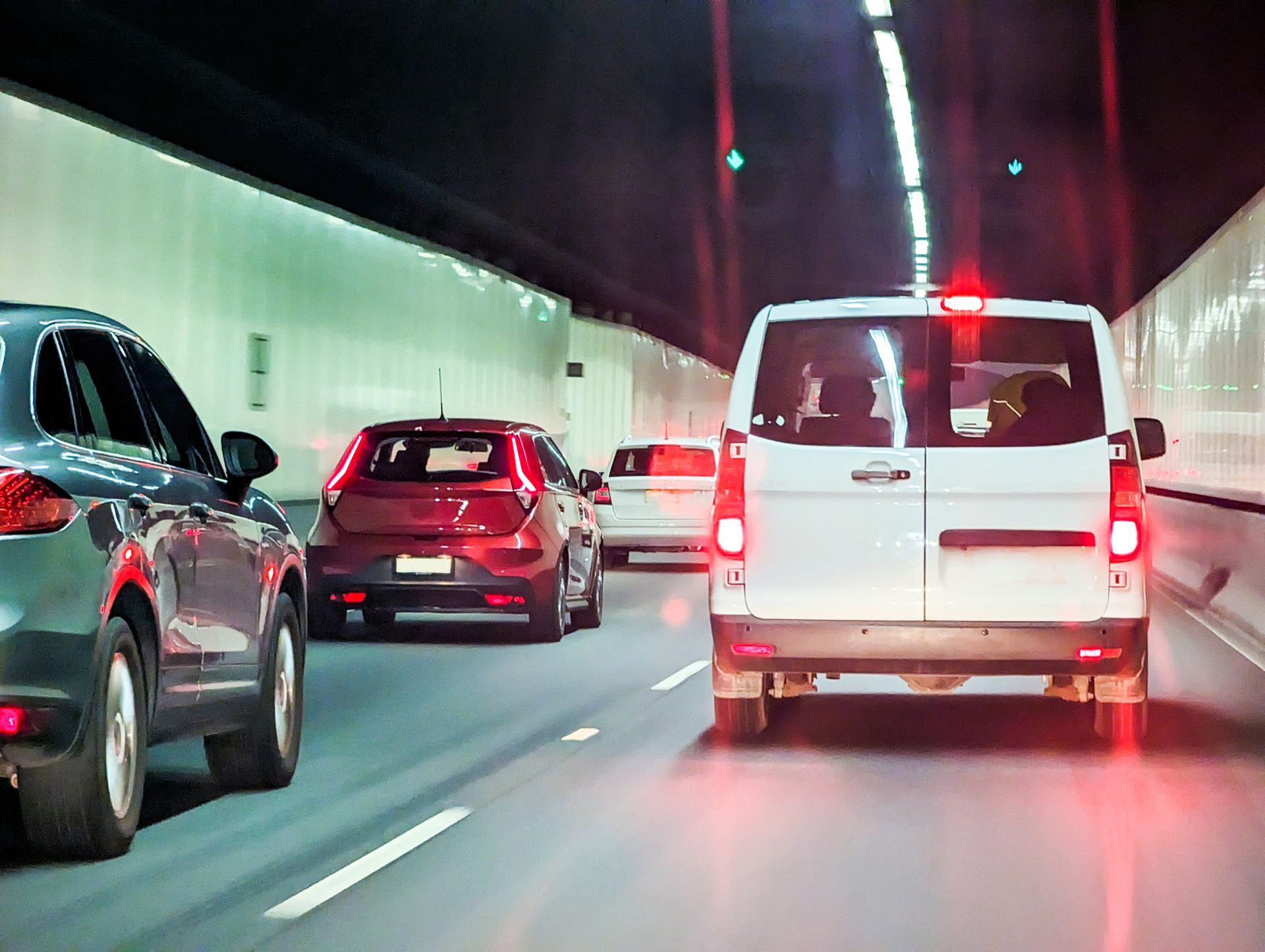 A white van is driving through a tunnel with other cars — Monroe, MI — Apex Legal Group