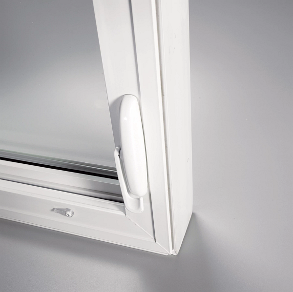 Close-up of a white window frame with a handle on a light gray background