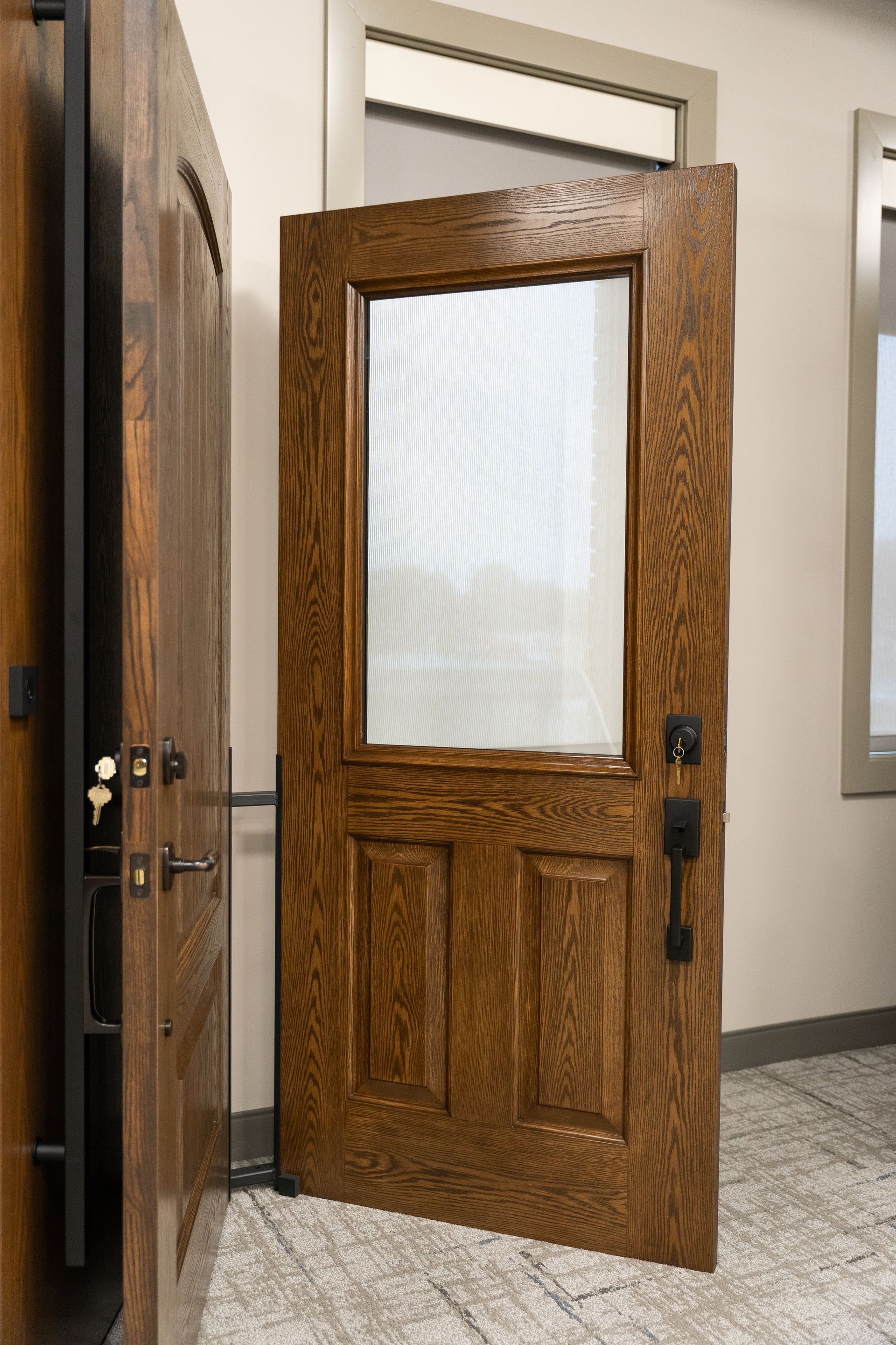 Partially open wooden door with frosted glass pane in a hallway