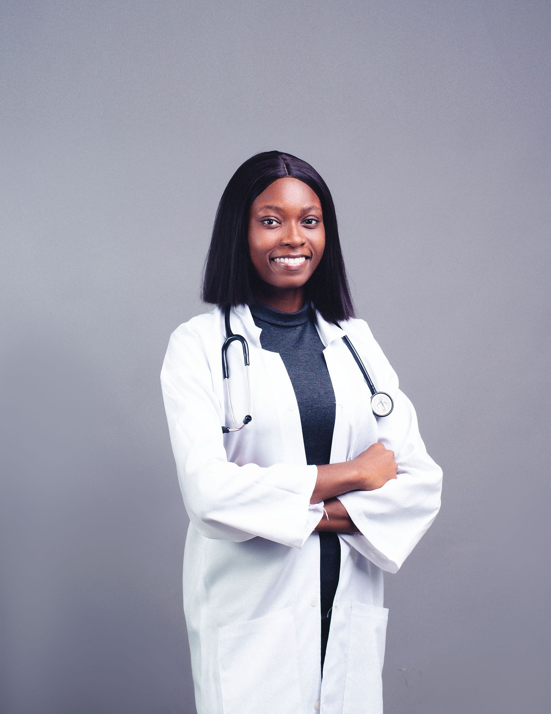 A clinician standing as if speaking to someone else, but you cannot see anyone else but the clinician