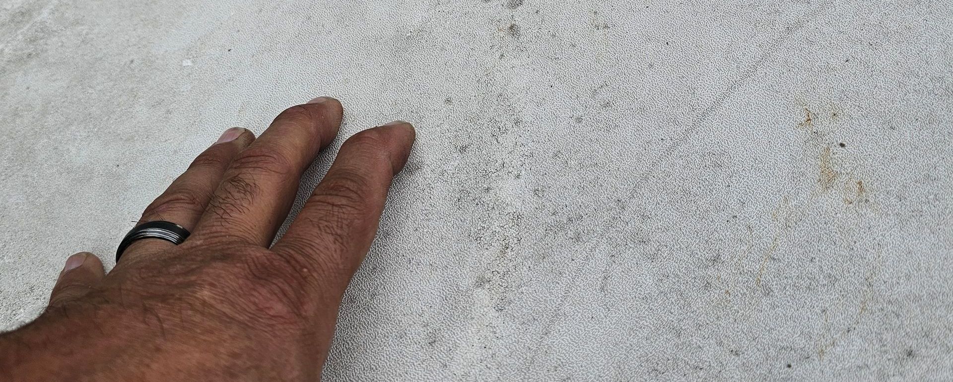 A man's hand on the roof of an RV