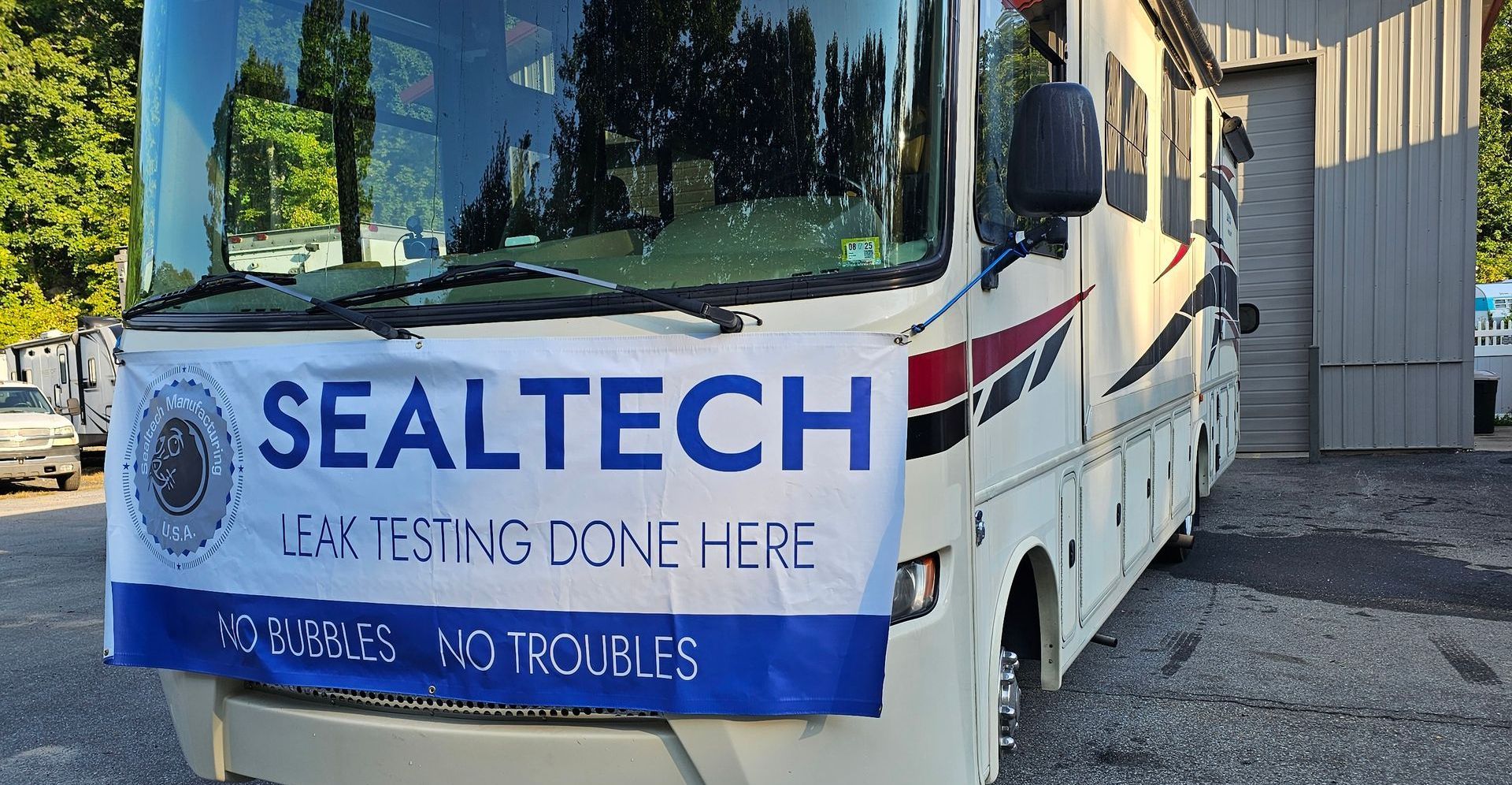 An RV with a SEALTECH sign on it that says