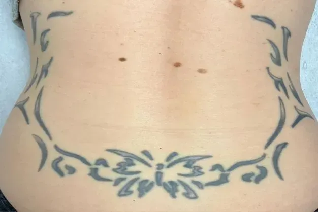 Back with black tribal tattoo design.