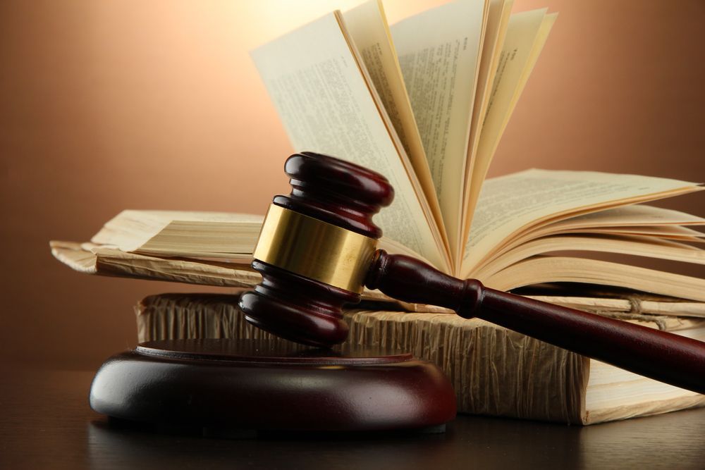 A Wooden Gavel Rests on A Base in Front of An Open Book — Mitchell Playford & Radburn Solicitors in Grafton, NSW