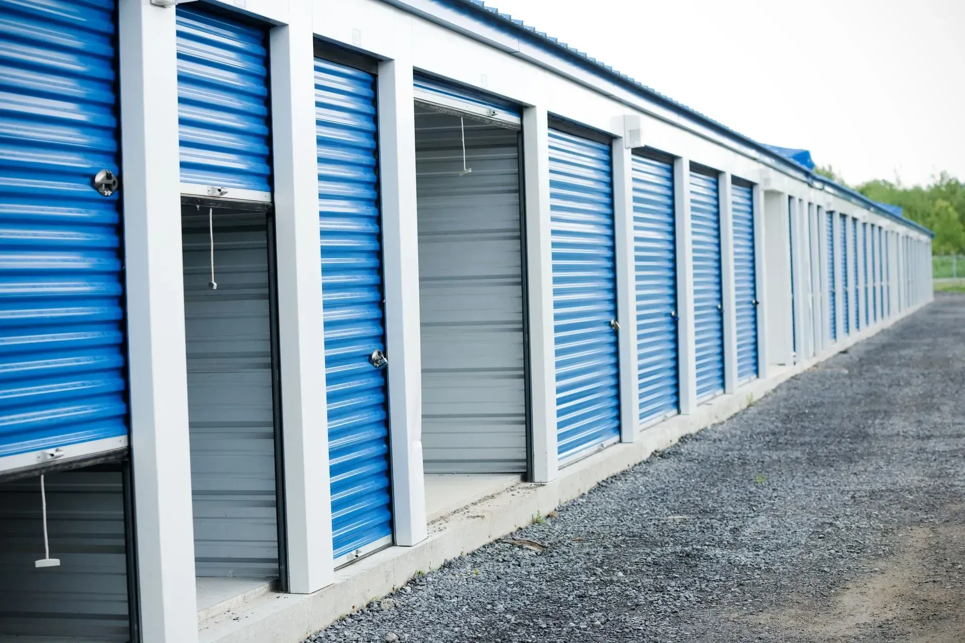 A row of blue and gray storage units with their doors open.