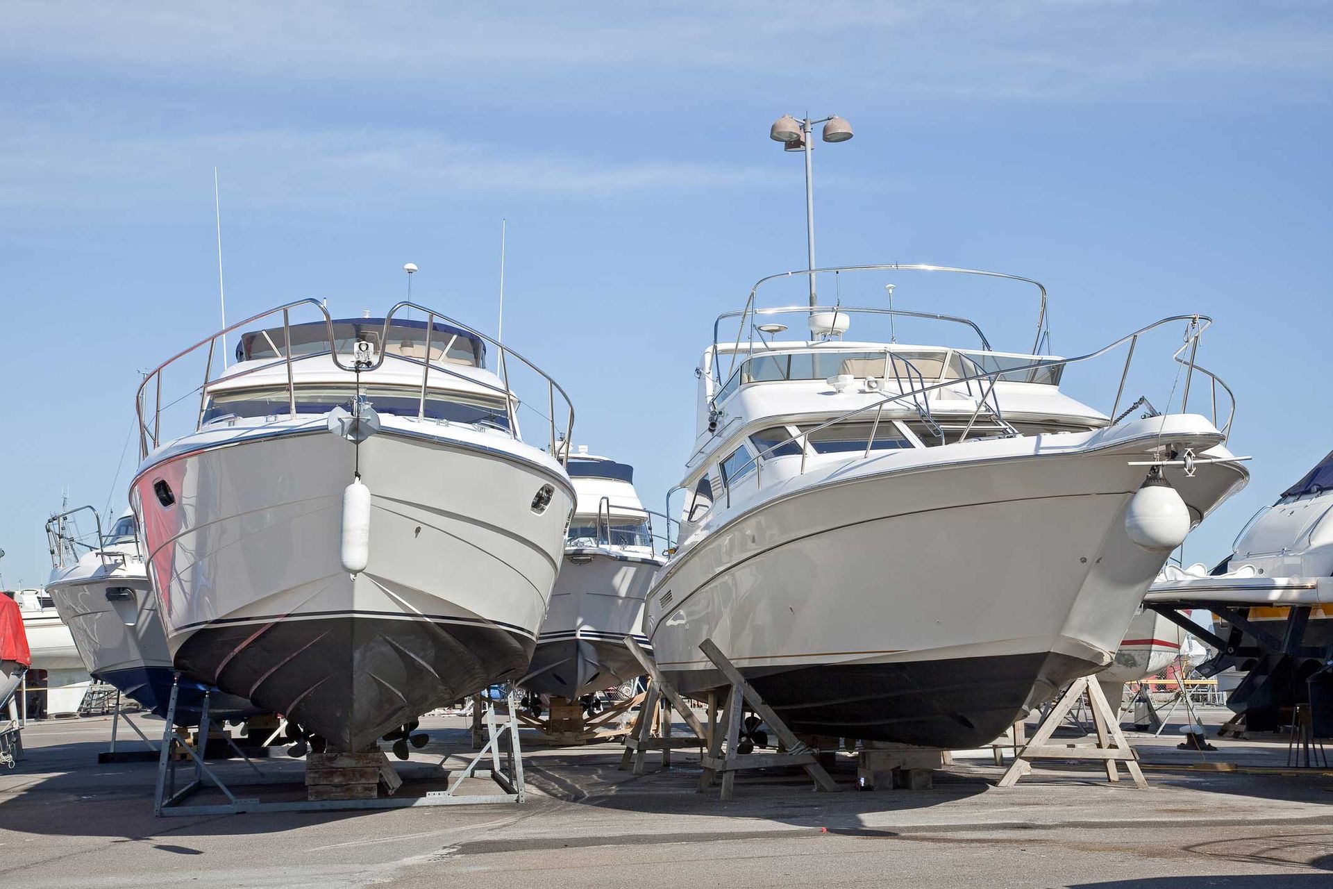 A row of boats are parked in a marina. A row of boats are parked in a marina.