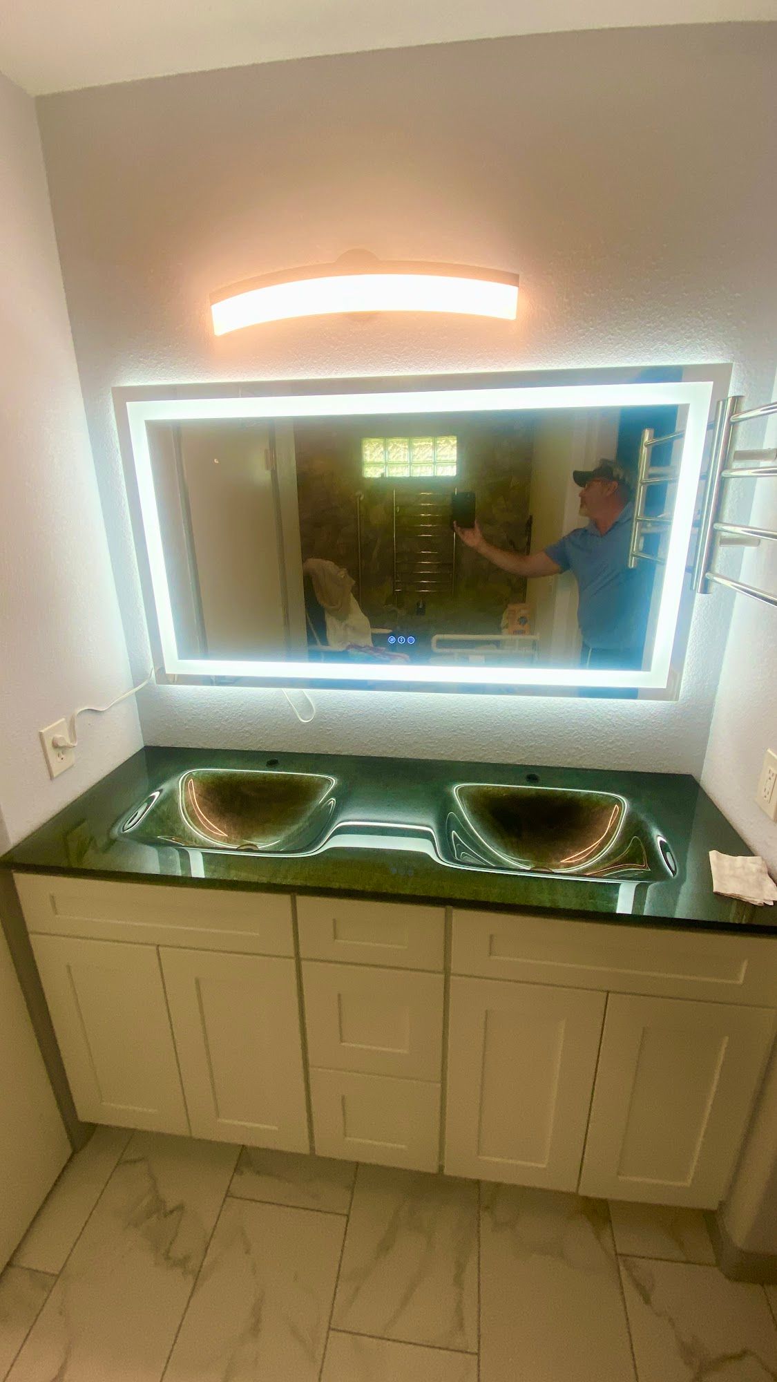 White bathroom with a sink, mirror, toilet, and shower/tub.