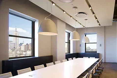 Modern office conference room with a long white table
