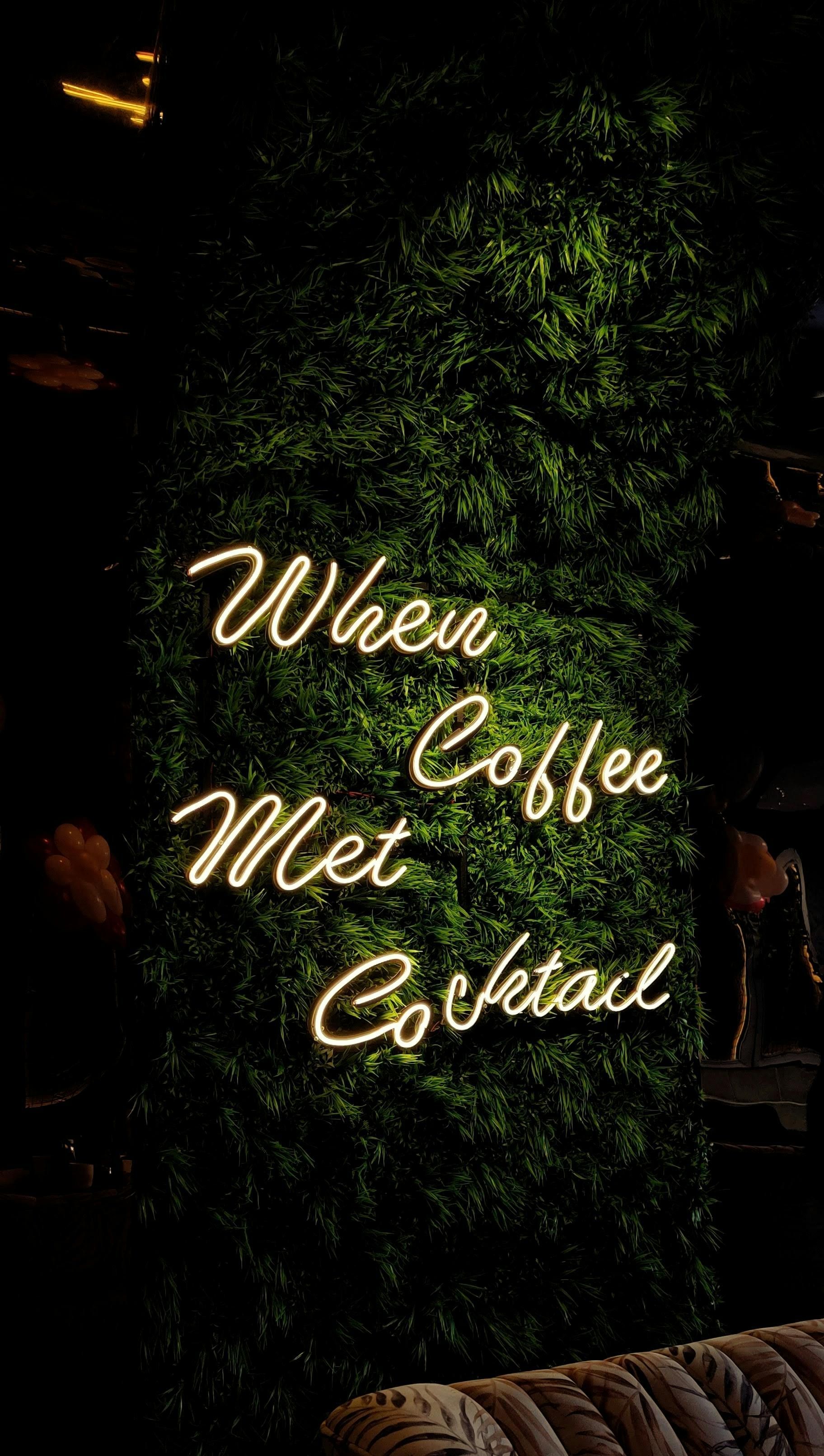 Neon sign on green foliage: 