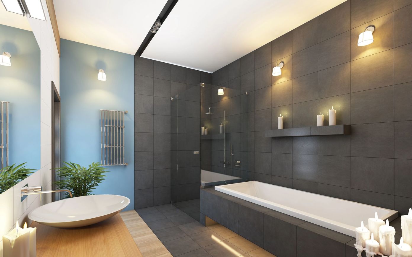 Bagno moderno con pareti rivestite in piastrelle scure, vasca freestanding, cabina doccia e lavabo rotondo con piante.