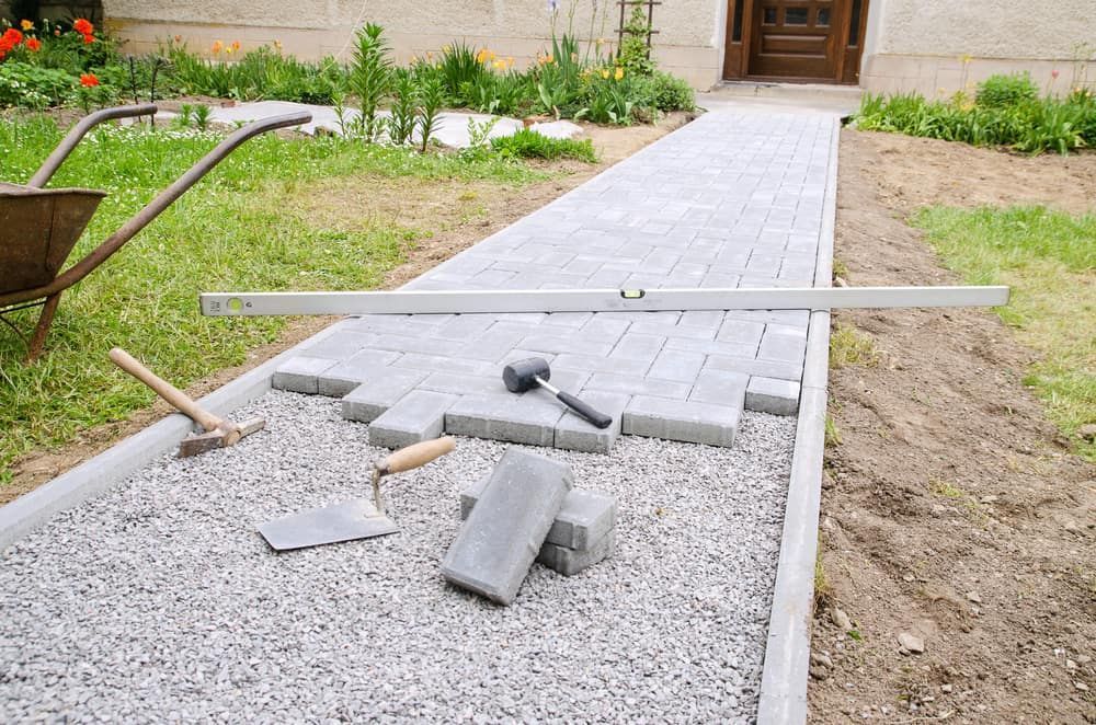 A Walkway is Being Built in a Yard With a Wheelbarrow — Jaya Rose Earthworks and Landscape Contractors In Gulmarrad, NSW