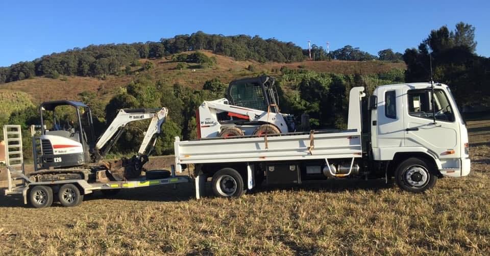 A White Truck With a Trailer  — Jaya Rose Earthworks and Landscape Contractors In Gulmarrad, NSW