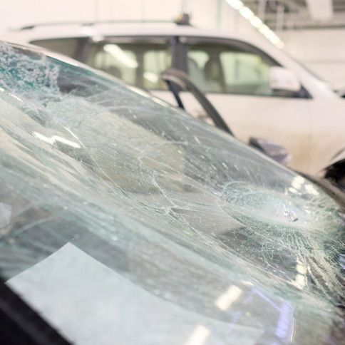 A close up of a broken windshield on a car.