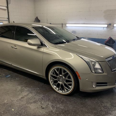 A silver car is parked in a garage.