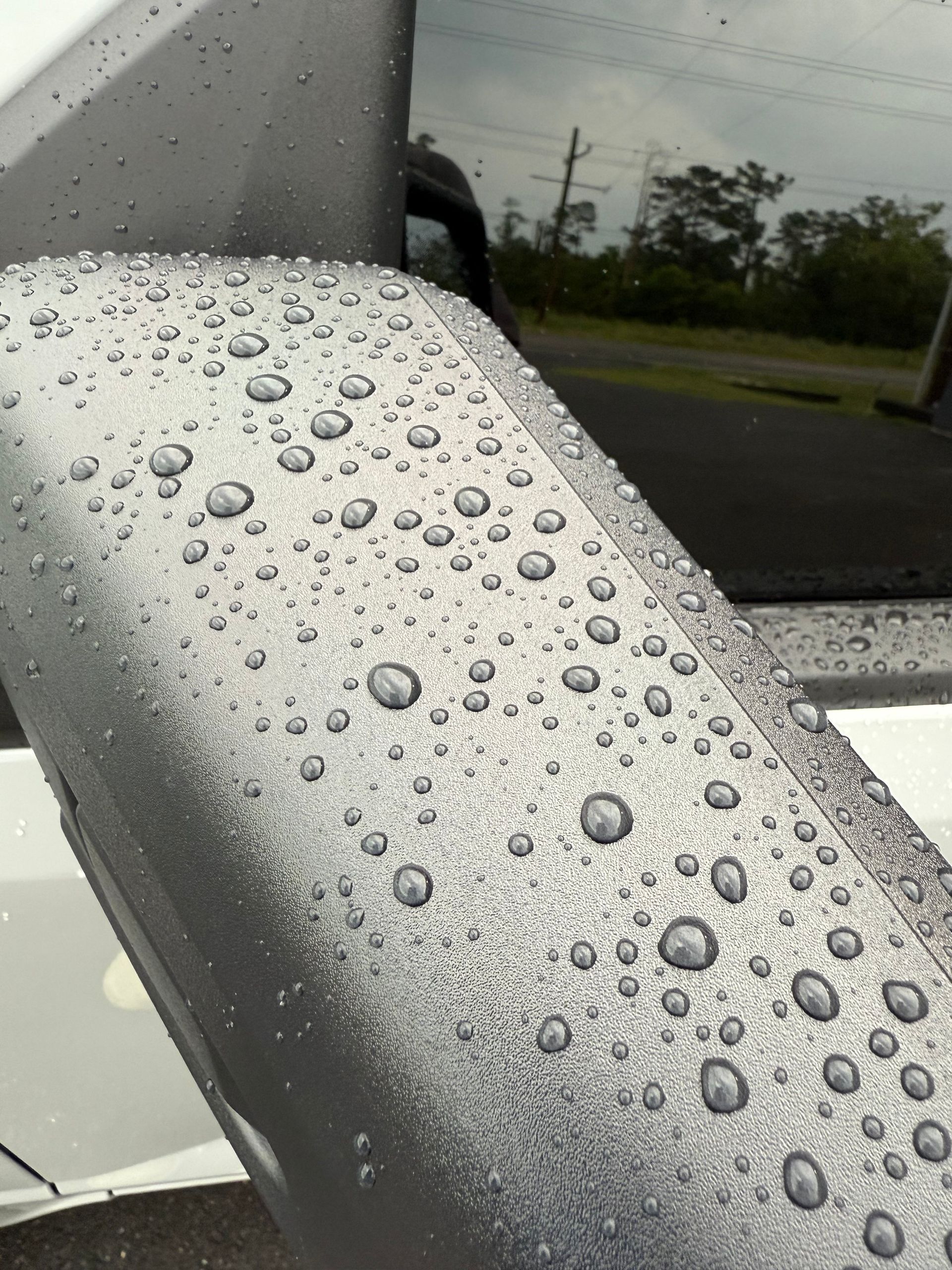 A close up of a car with water drops on it