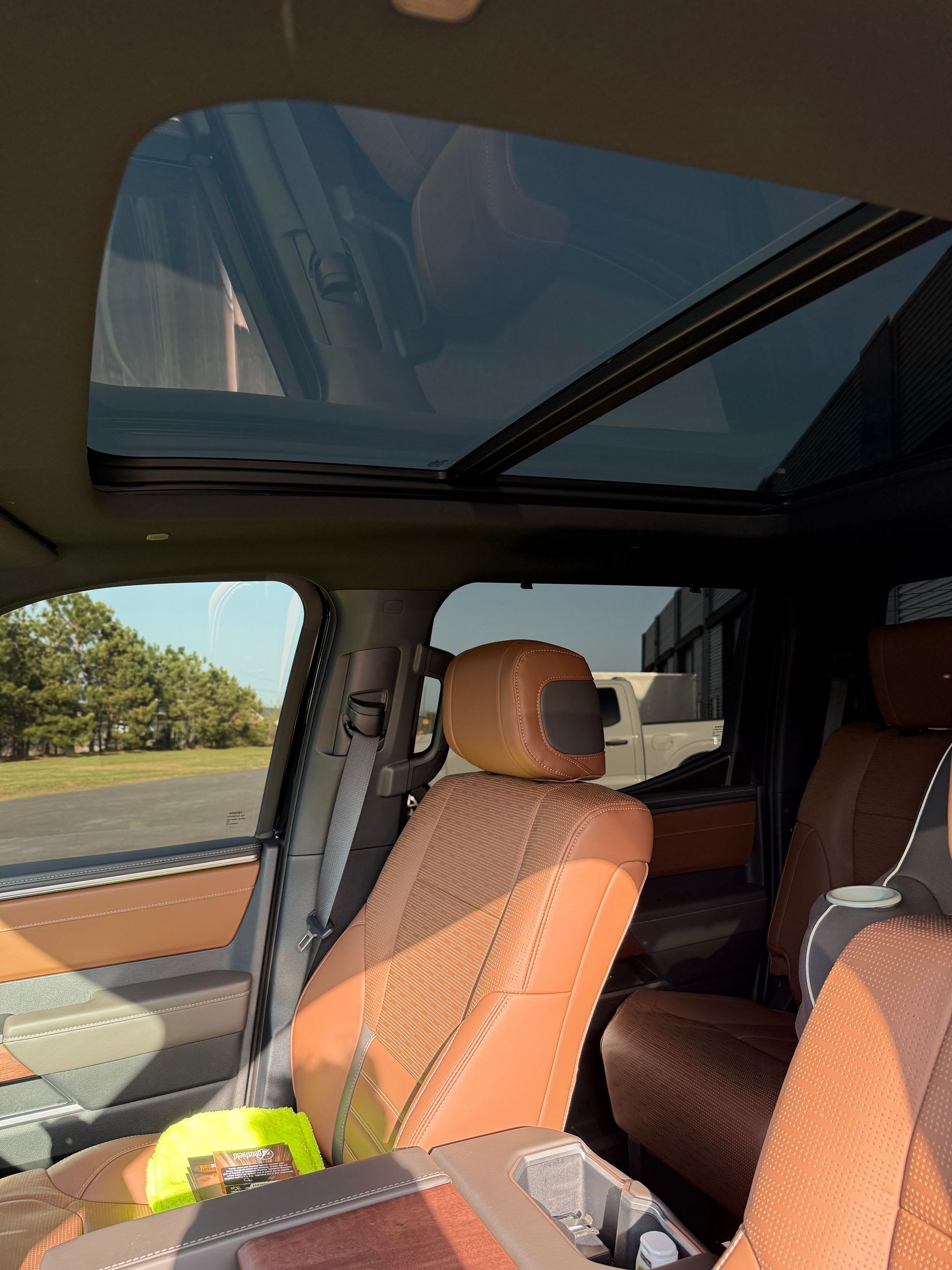 The inside of a car with the sunroof open