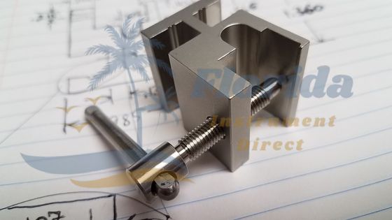 Metal clip over engineering blueprint with pen and pencil