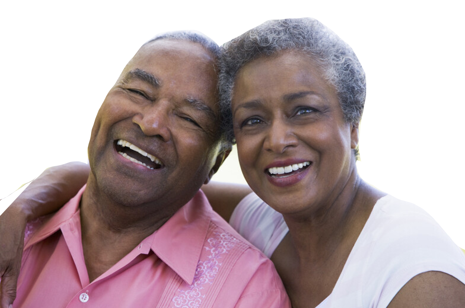 Smiling elderly Black couple embracing outdoors. The man wears a pink shirt, the woman a white top.