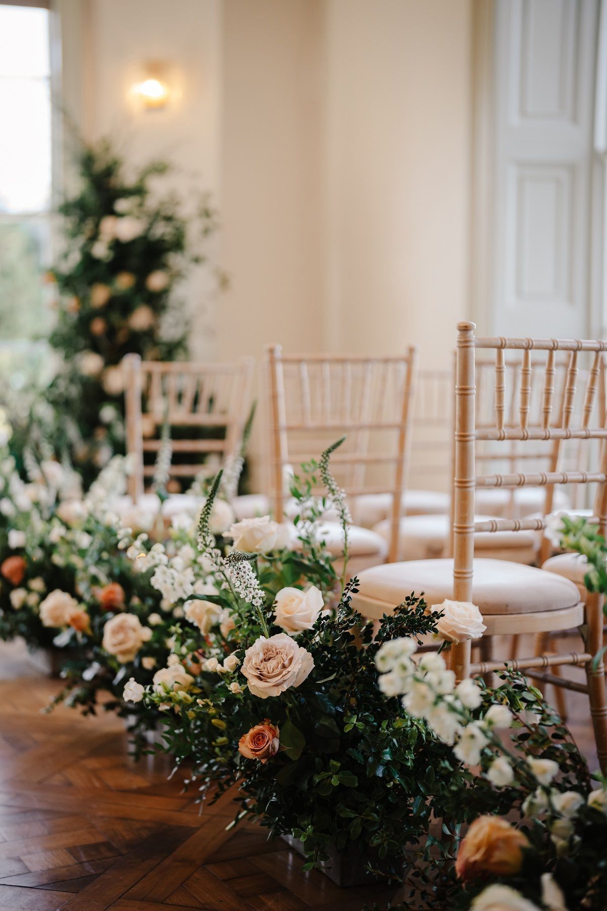 a bride and groom are standing in front of a crowd during their wedding ceremony .