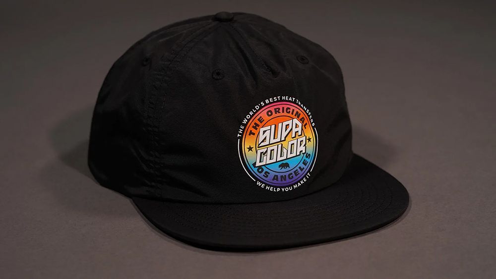 A Black Hat With Supa Color Logo on It — Carnival Clothing In Miami, QLD