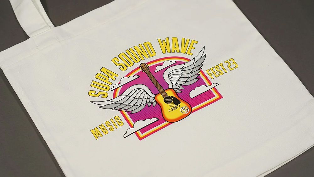 A White Tote Bag With a Guitar With Wings on It — Carnival Clothing In Miami, QLD