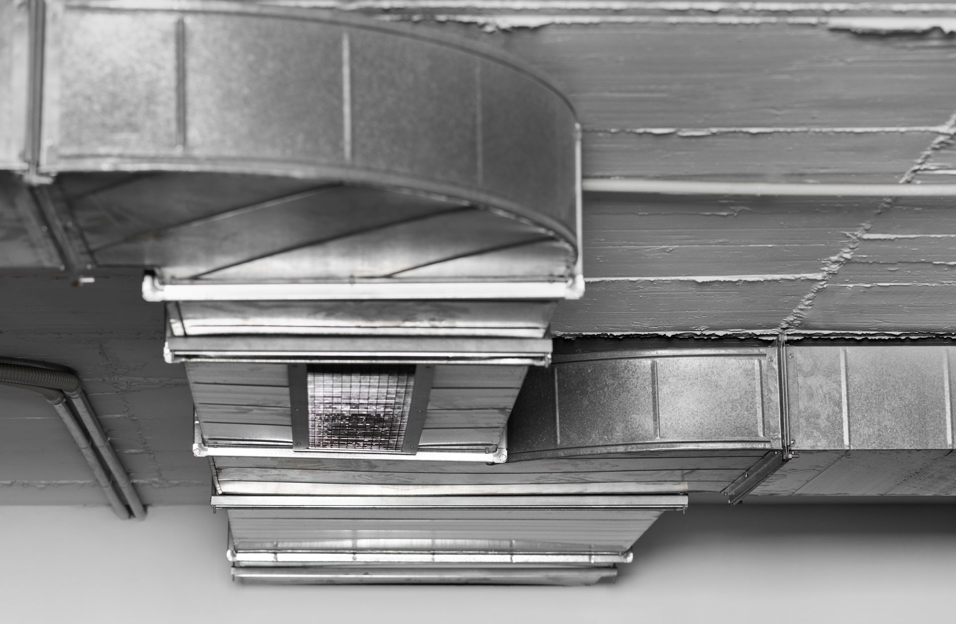 A yellow house with a tree in front of it