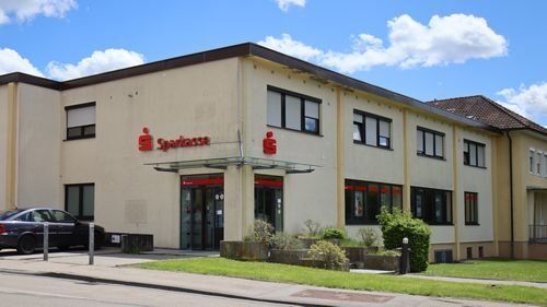 Sparkasse Rügländer Straße 6, zweigeschossiges Gebäude, davor Gehweg und Straße