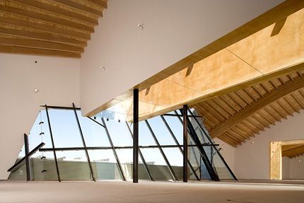 Empty modern office with glass-walled room and construction materials in a bright unfinished space
