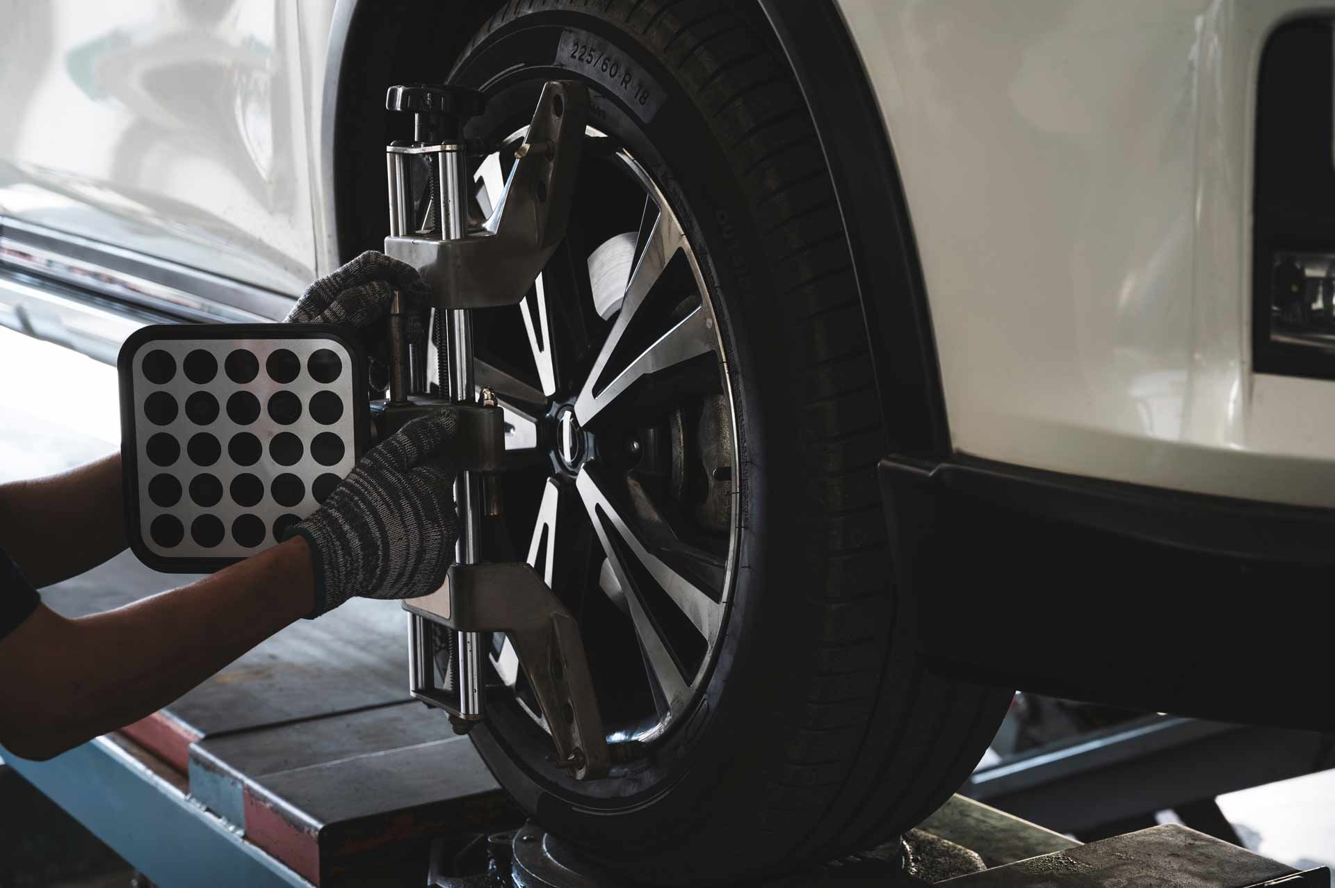 Car wheel being aligned with a laser alignment machine in an auto shop