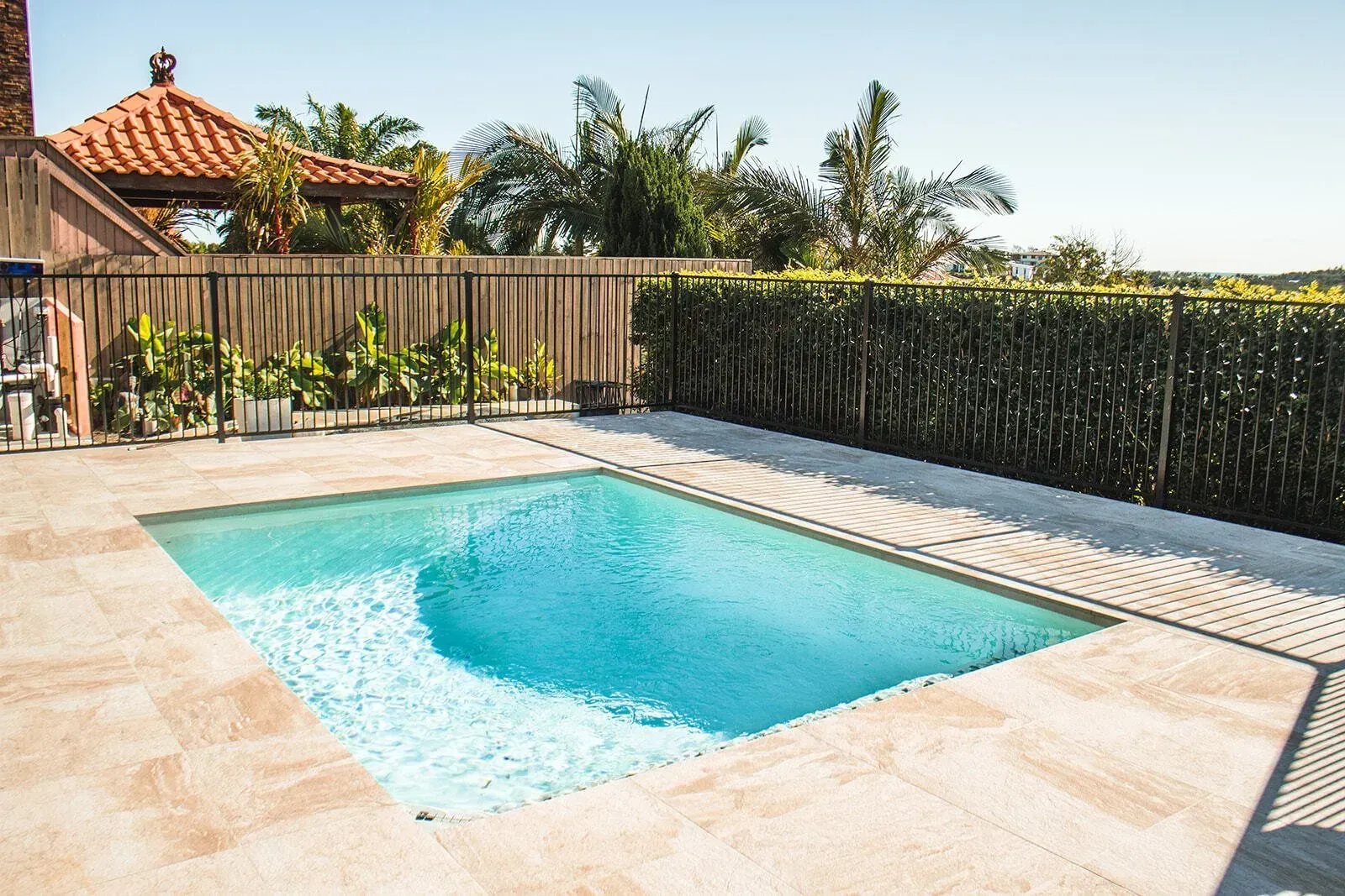A Small Square Swimming Pool With Fencing In The Backyard — Doug Allen Pools In Beaconsfield, QLD