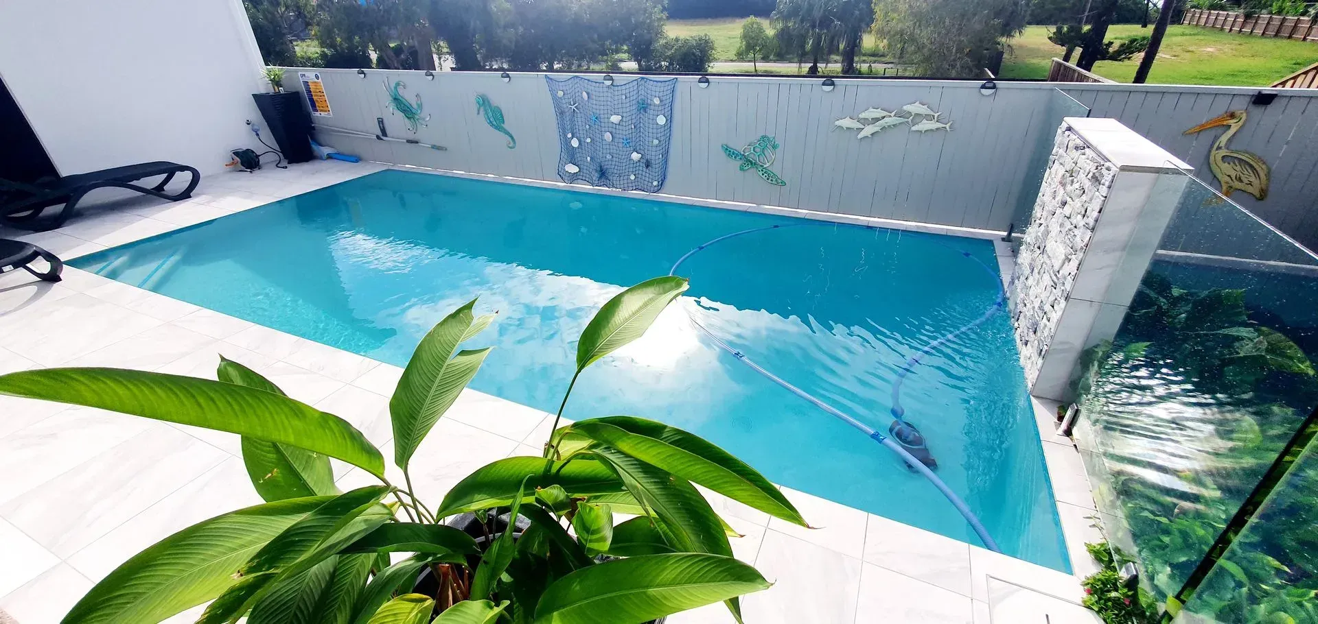 White Stone Swimming Pool With Waterfall Feature — Doug Allen Pools In Beaconsfield, QLD