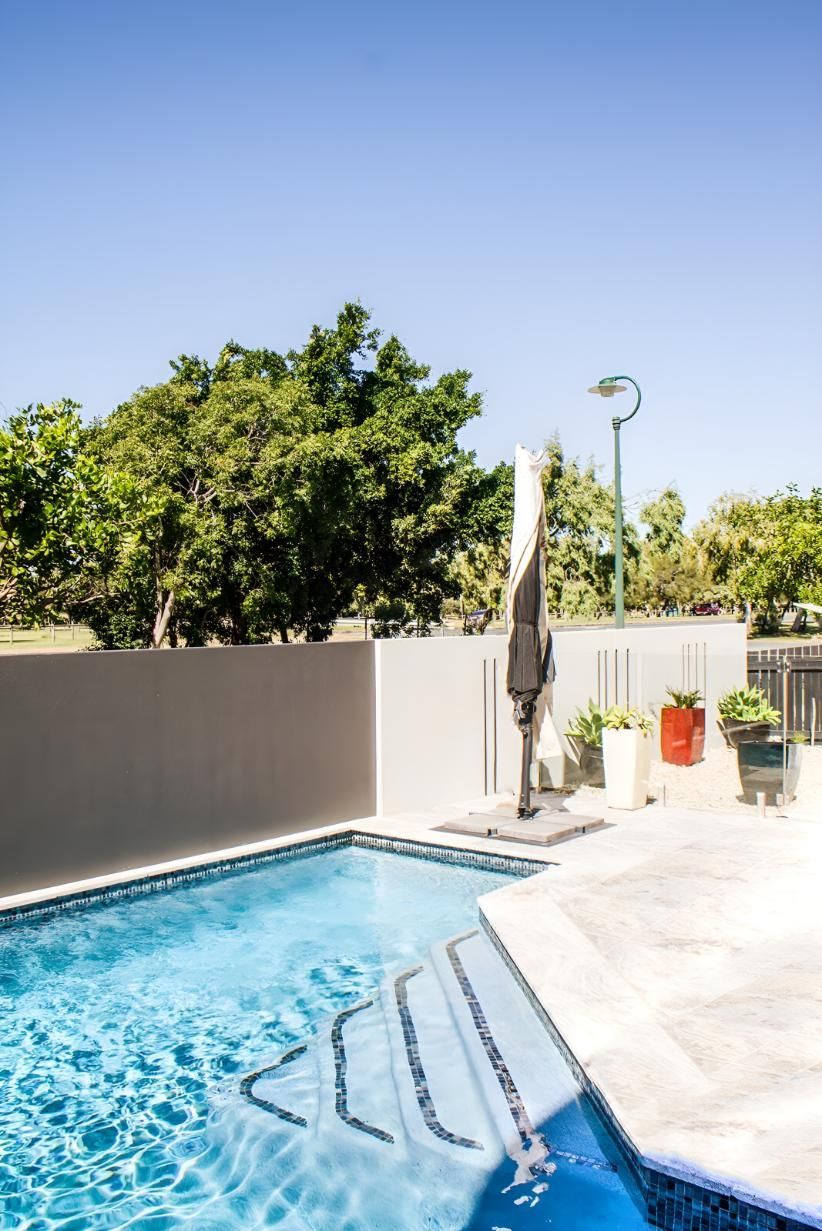 A Large Swimming Pool With Stairs Leading To It — Doug Allen Pools In Beaconsfield, QLD