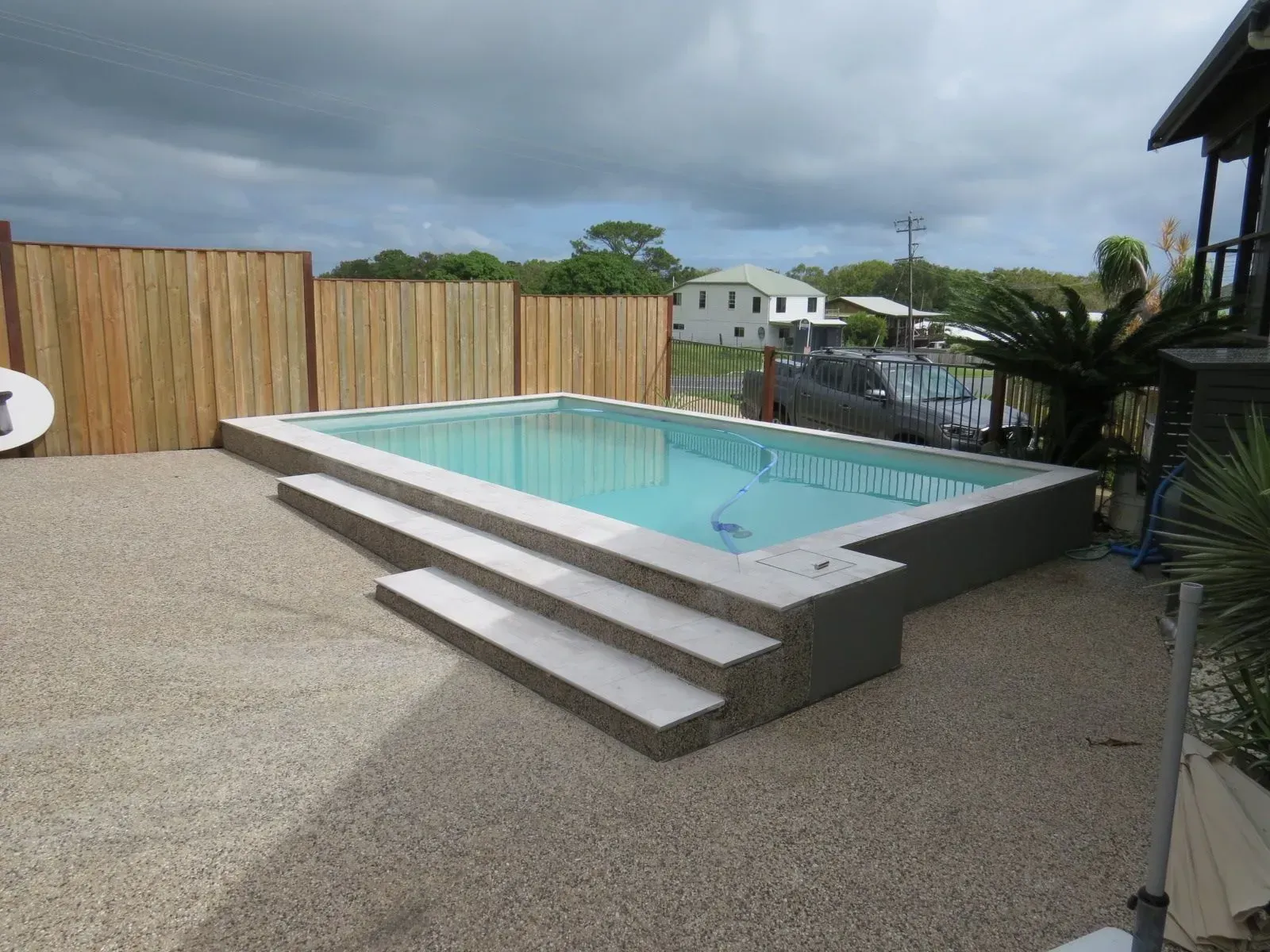 A Swimming Pool With Tile Steps In The Backyard — Doug Allen Pools In Beaconsfield, QLD