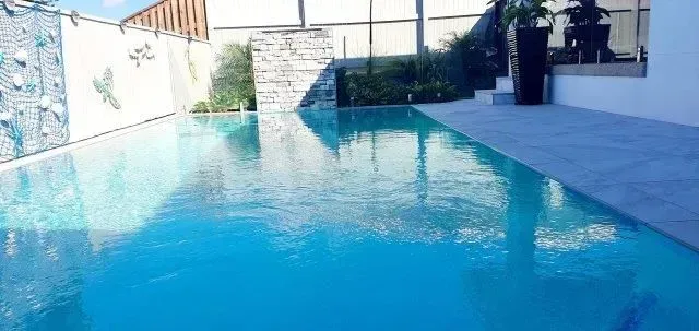 A Swimming Pool With Rock Wall Waterfall Feature — Doug Allen Pools In Beaconsfield, QLD