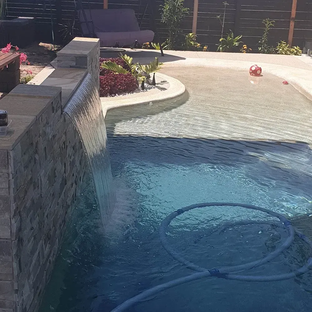 A Swimming Pool Waterfall Feature In The Backyard — Doug Allen Pools In Beaconsfield, QLD