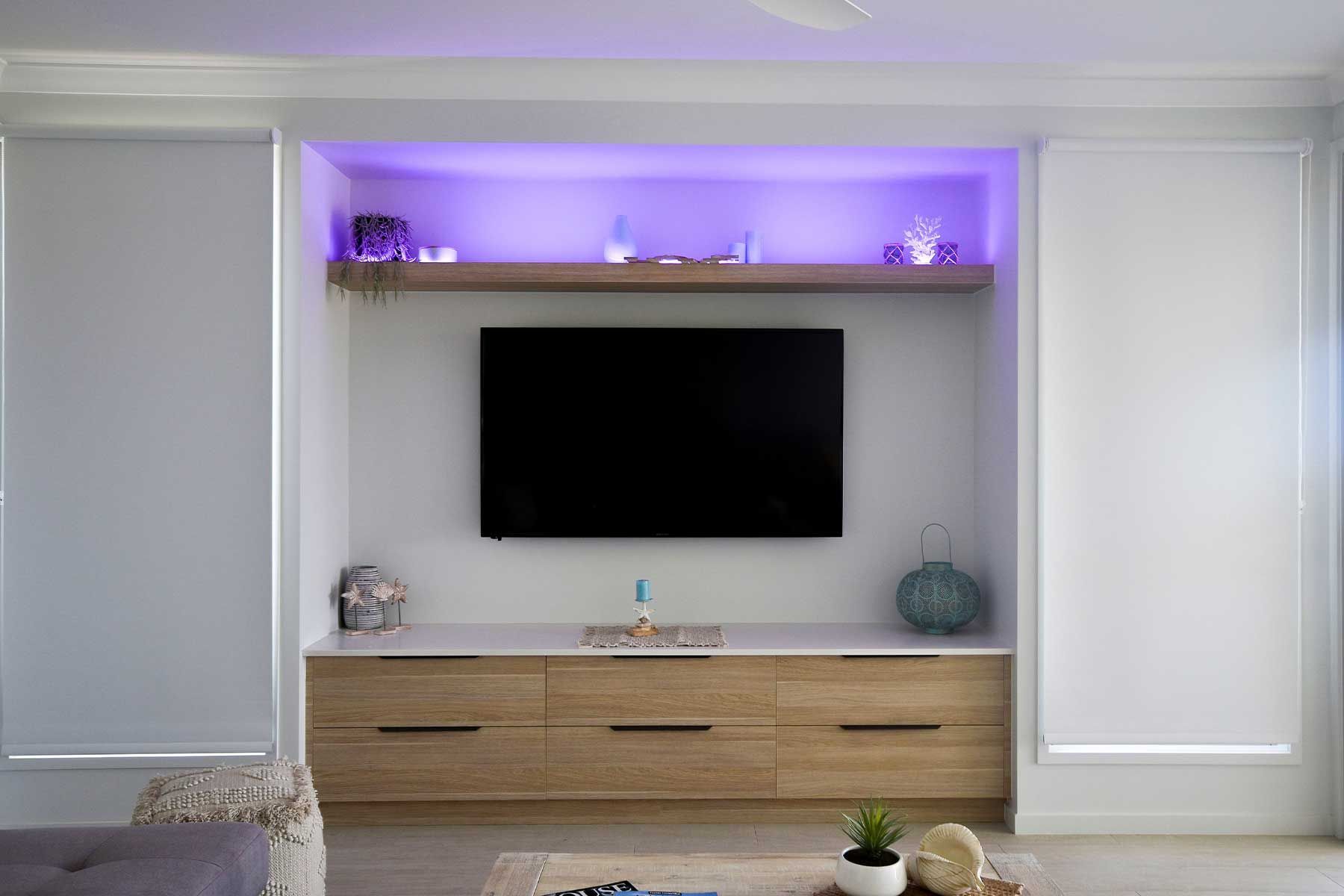 Modern Living Room with A Wall-Mounted Tv — Bundy Homes in Bundaberg North, QLD