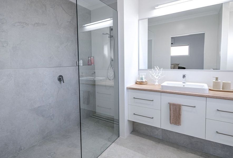 Modern Gray Bathroom with Glass Shower — Bundy Homes in Bundaberg North, QLD