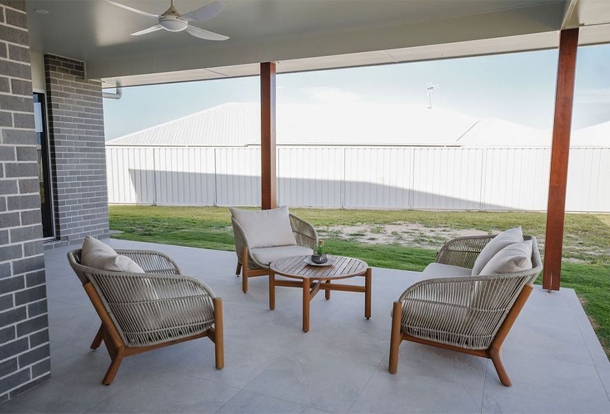 Covered Patio with Wicker Chairs and A Table — Bundy Homes in Bundaberg North, QLD