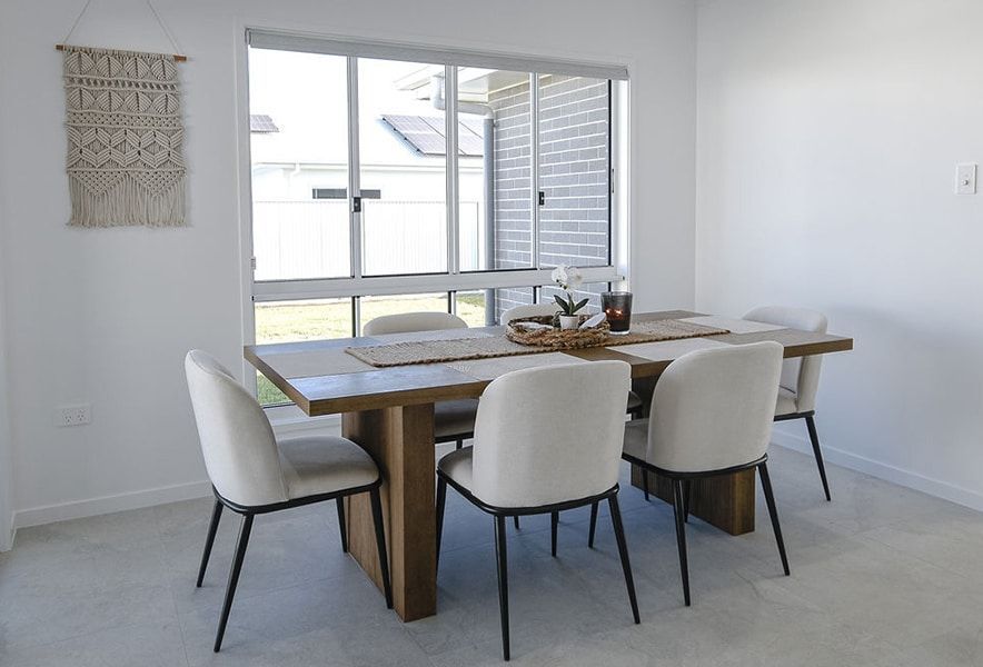 Bright Dining Room with A Wooden Table — Bundy Homes in Bundaberg North, QLD