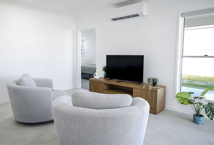 Bright Modern Living Room with A Sofa — Bundy Homes in Bundaberg North, QLD