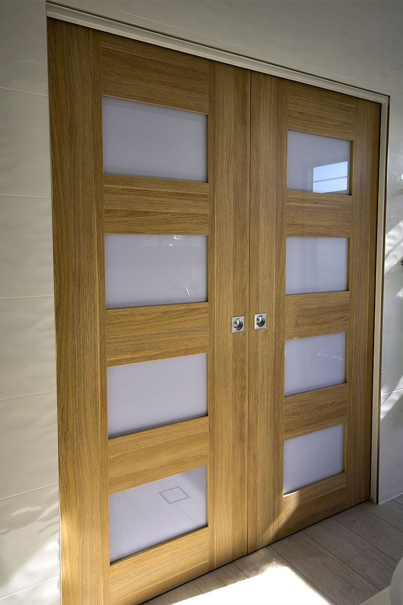 Wooden Double Doors with Frosted Glass Panels in A Hallway — Bundy Homes in Bundaberg North, QLD