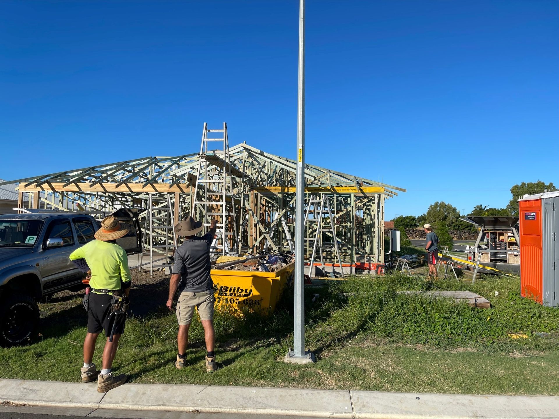 Two Workers Near a Damaged Metal Frame — Bundy Homes in Bundaberg North, QLD