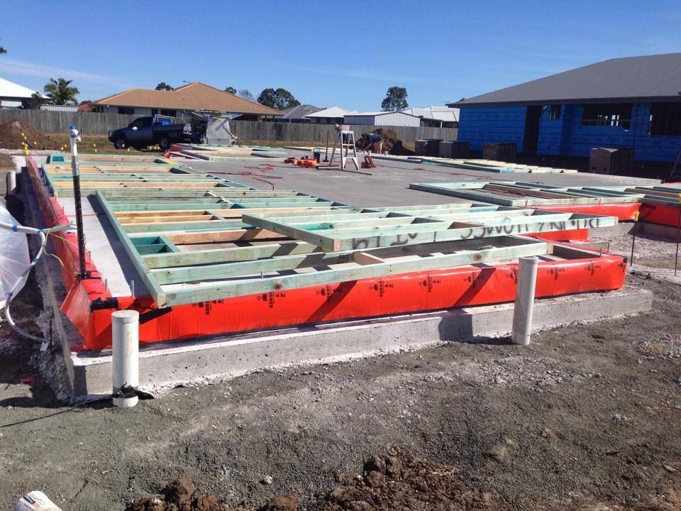Foundation Slab Under Construction with Red Formwork and Concrete Footings — Bundy Homes in Bundaberg North, QLD