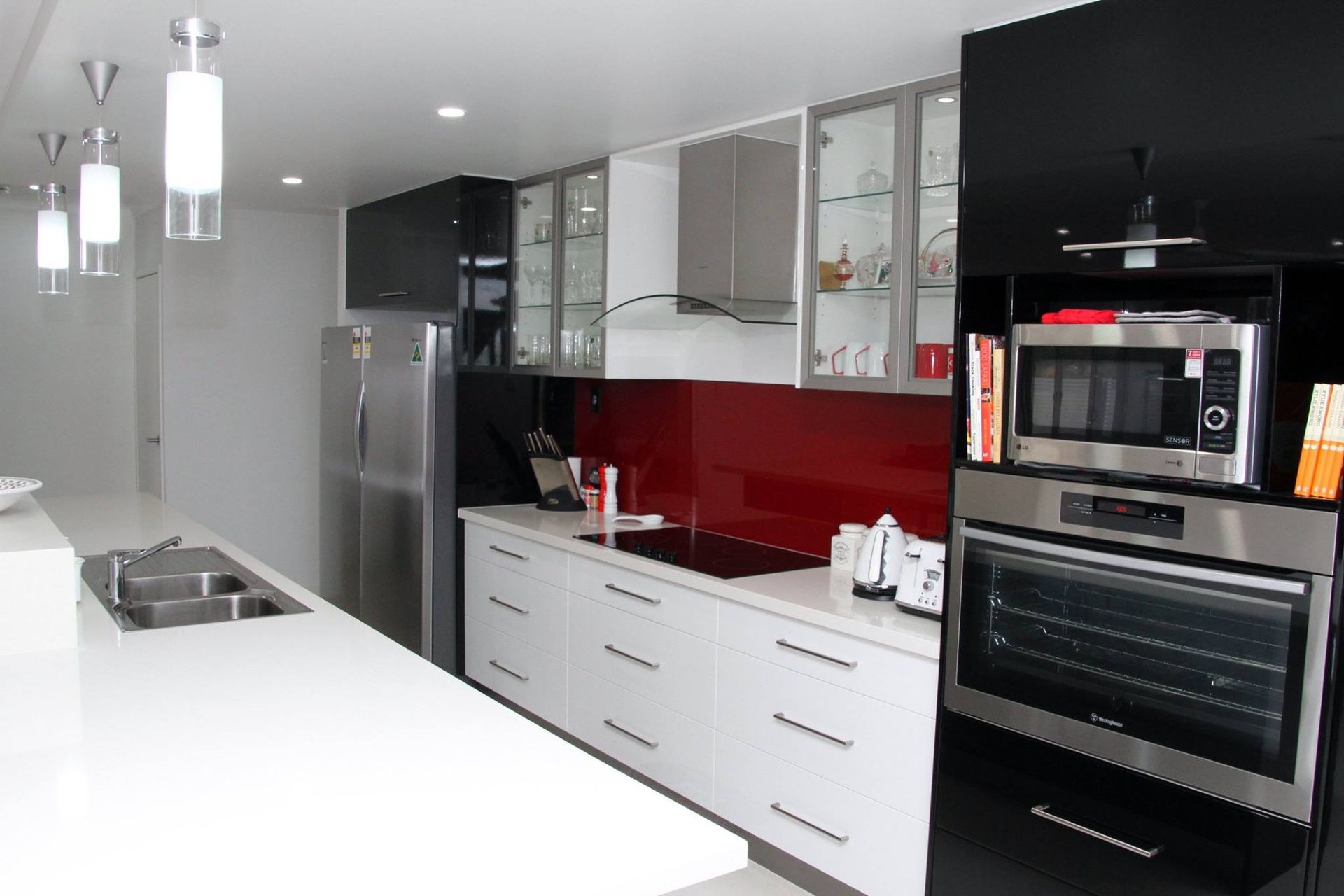 Modern White Kitchen with Stainless Appliances — Bundy Homes in Bundaberg North, QLD